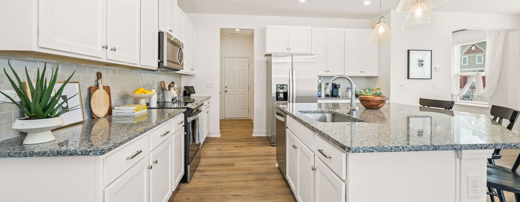 a kitchen with white cabinets
