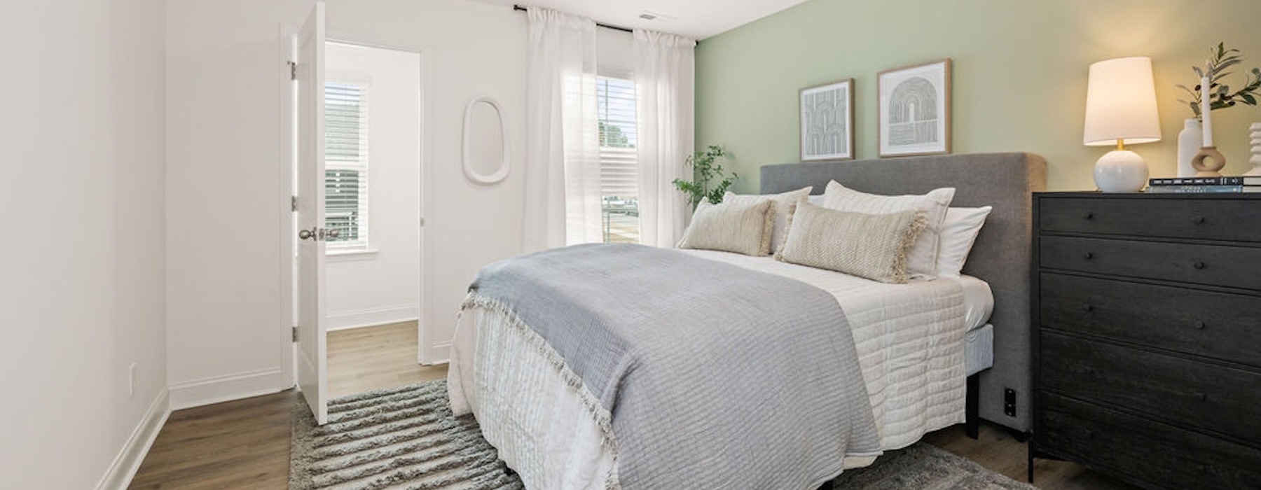a bedroom with a bed and a dresser